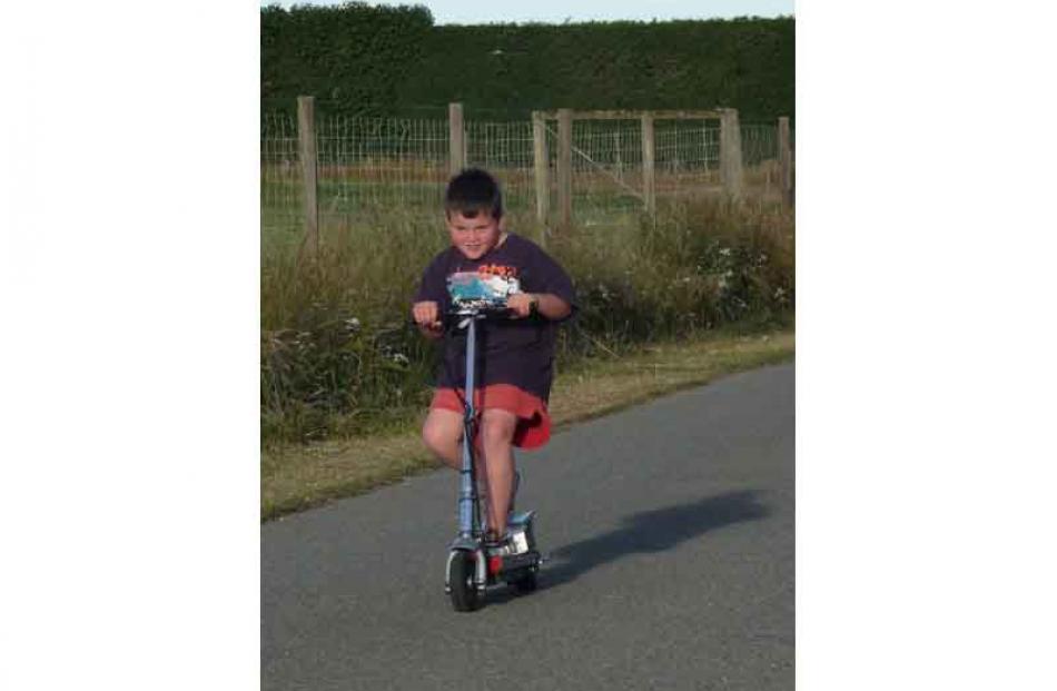 Just me and my shadow . . . Max McCallum (8) on his new electric scooter. Photo: Lois Davis