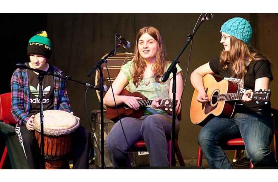 Friends Lily LeBrun, Maura Turner, and Libby Atkinson perform at Whare Flat 2 January 2011. Photo...
