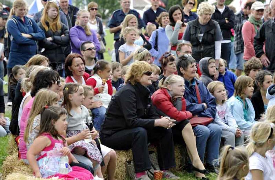 The crowd enjoys a magic show.