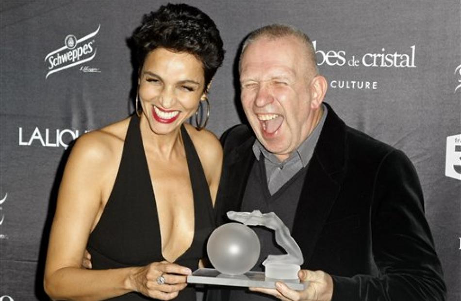 French fashion designer Jean Paul Gaultier, right, with muse and model Farida Khelfa holds the...