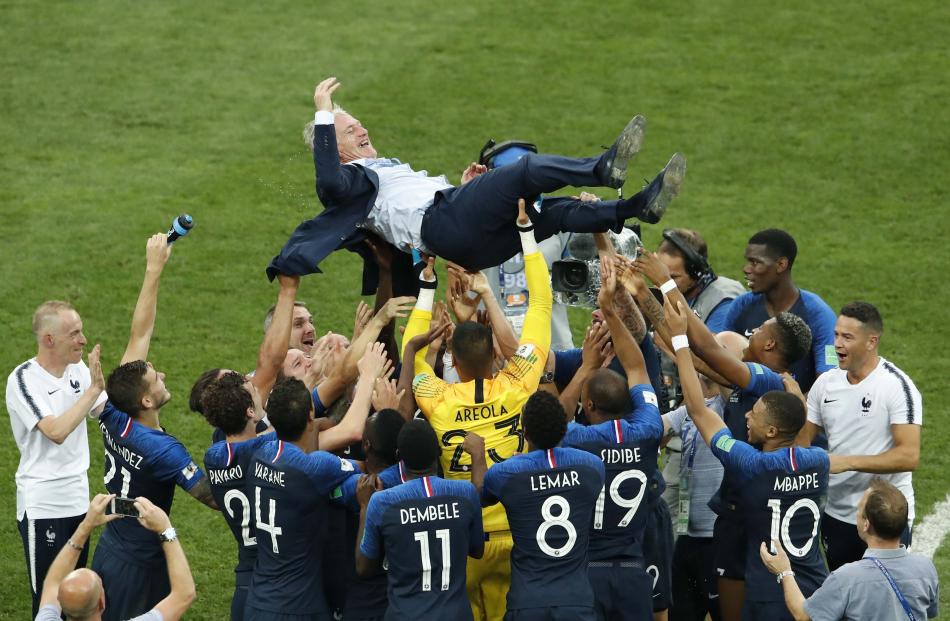 France players celebrate winning the World Cup with coach Didier Deschamps. Photo: Reuters