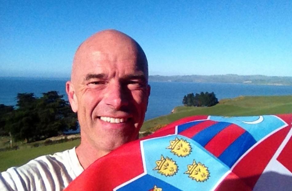 Glenn Besley proudly displays the Croatian flag after they won their football World Cup semifinal...