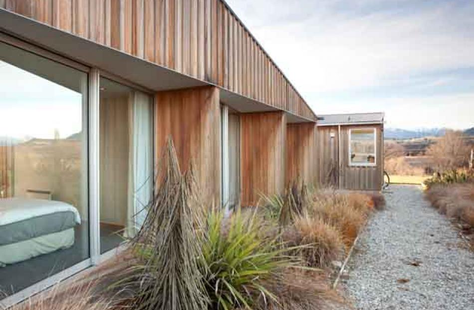 Cedar board and batten cladding covers the bedroom wing.
