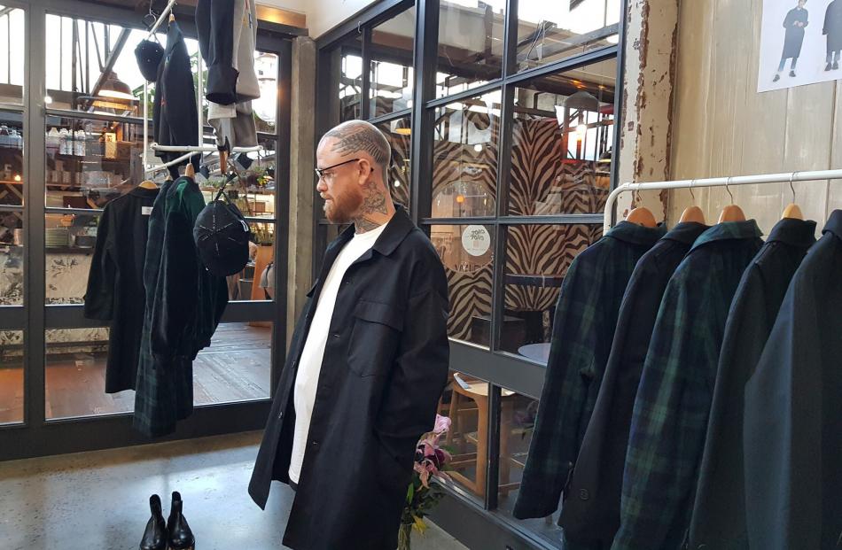 A customer tries on a jacket in Jun’s Ponsonby pop-up store