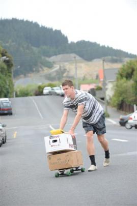 Second-year student Wade Kelly (19) moves items to his flat.