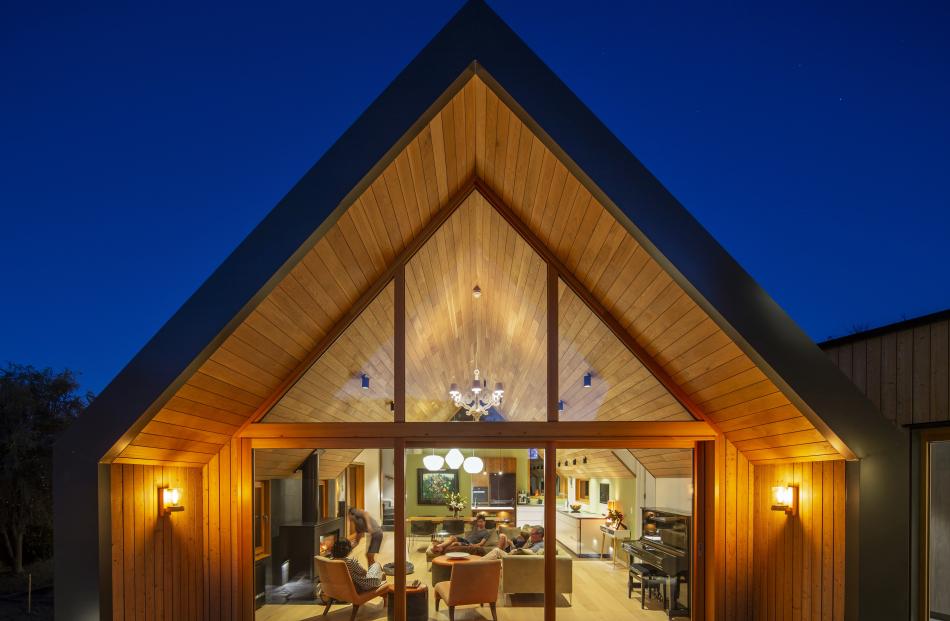 The roof of the home photographed at night.