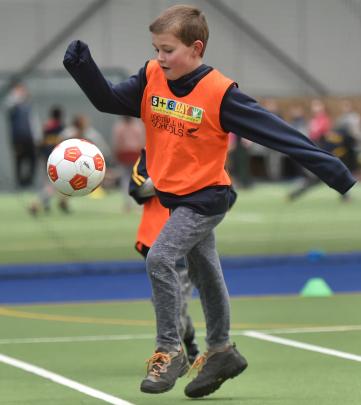 Balaclava School pupil Leo Parker (8) has a go at football. 