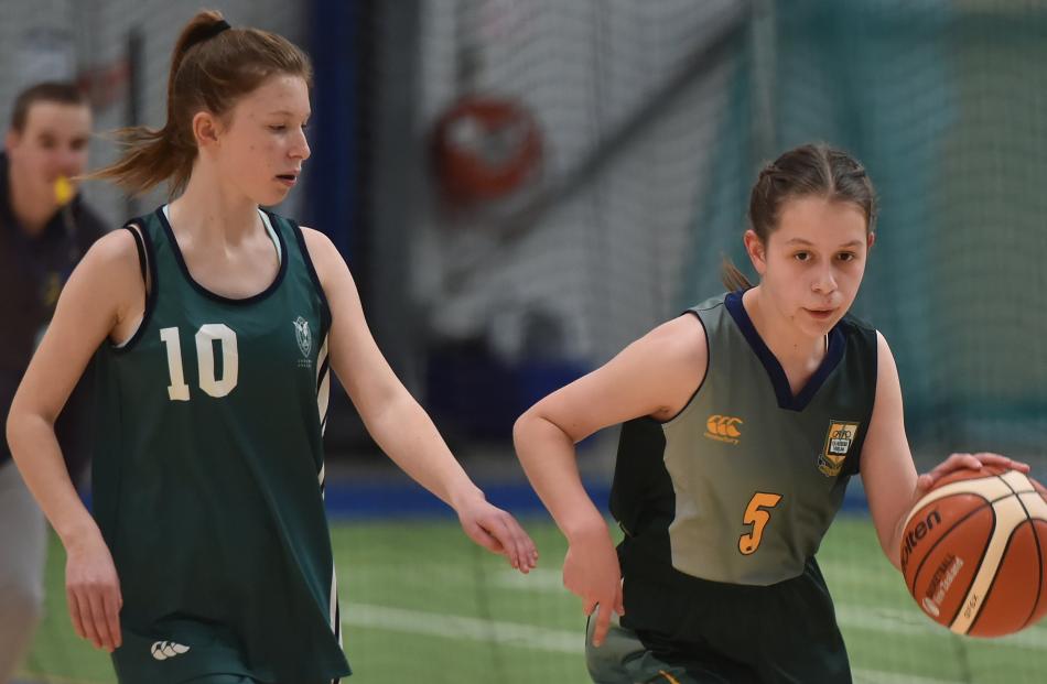 Bayfield High School player Veronika Luthar dribbles the ball down the court with St Hilda's Collegiate player Tamzin Burgess in pursuit. Photos: Gregor Richardson