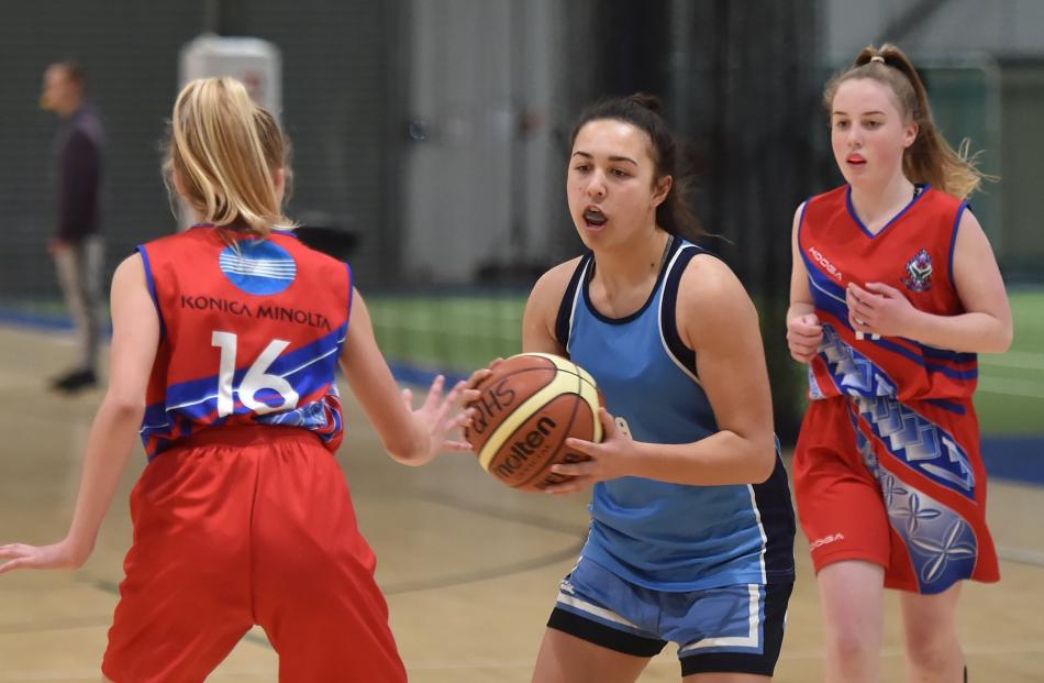 Sarah Kruishoop (centre, Queen's High School) looks to pass St Hilda's Collegiate defender Ria Dennison. Behind is Phoebe Parker (Queen's).