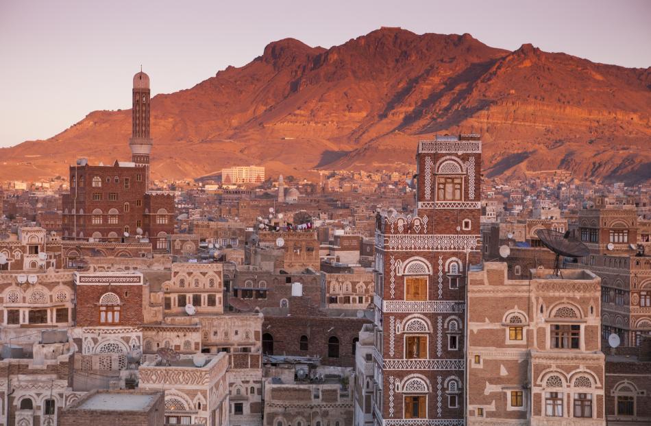 View over Old Town Sanaa rooftops at sunset. Photo: Getty Images