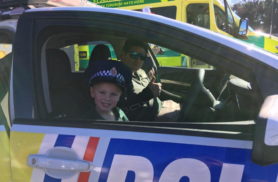 Laikyn Triggs (4), of Temuka, takes the wheel of a police car while her dad, Brad (a driver for...