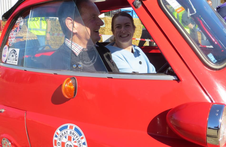 Rose Falloon, of Pleasant Point, takes a ride in the 300cc BMW Isetta with owner Alister Lobb.