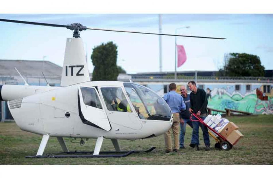 A helicopter of the  'Rangiora Express' welfare airlift drops off hot food to New Brighton.