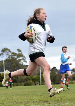 Rhianah Knopp-Jenkins (11), from Kaikorai Valley College, runs away to score at the Sassenachs intermediate rugby tournament at Bishopscourt yesterday. Photos: Peter McIntosh