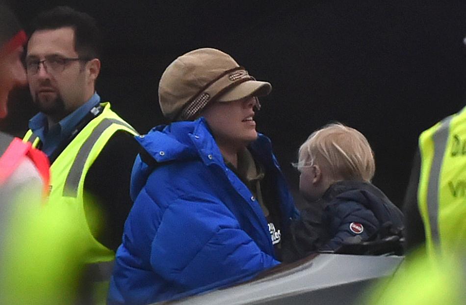 Pink and son Jameson wrap up warm after arriving on a private jet at a damp Dunedin Airport...