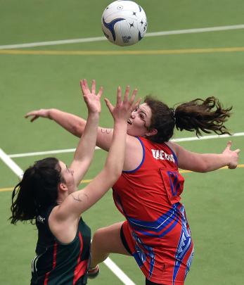Beth Scott, of Menzies College, looks to catch the ball ahead of Olivia Gray, of Queen's HIgh...
