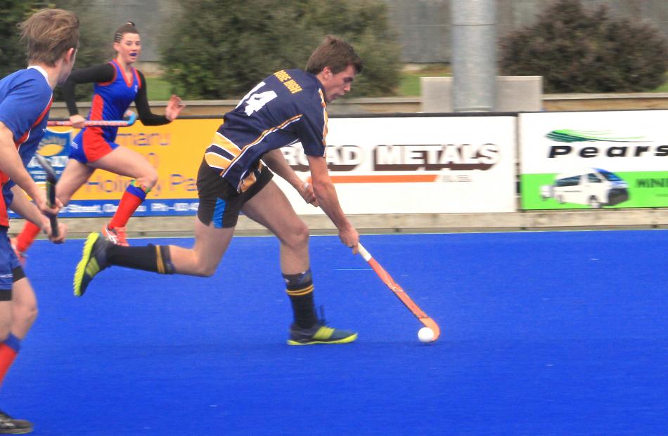 Gore High School's Andrew Allan blows past St Peter's College defenders as the Gore schools clash...