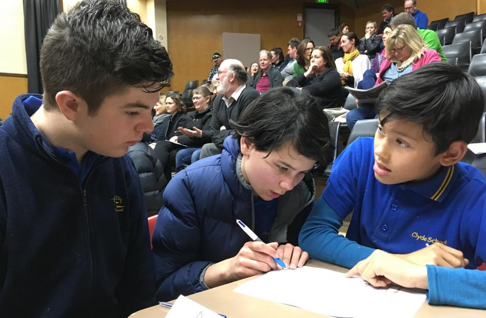 Clyde Primary School pupils (from left) Oscar Bartle (13, year 8), Jasmine Anderson (12, year 8) and Taine Morgan (11, year 7) confer during the year 7-8 quiz.