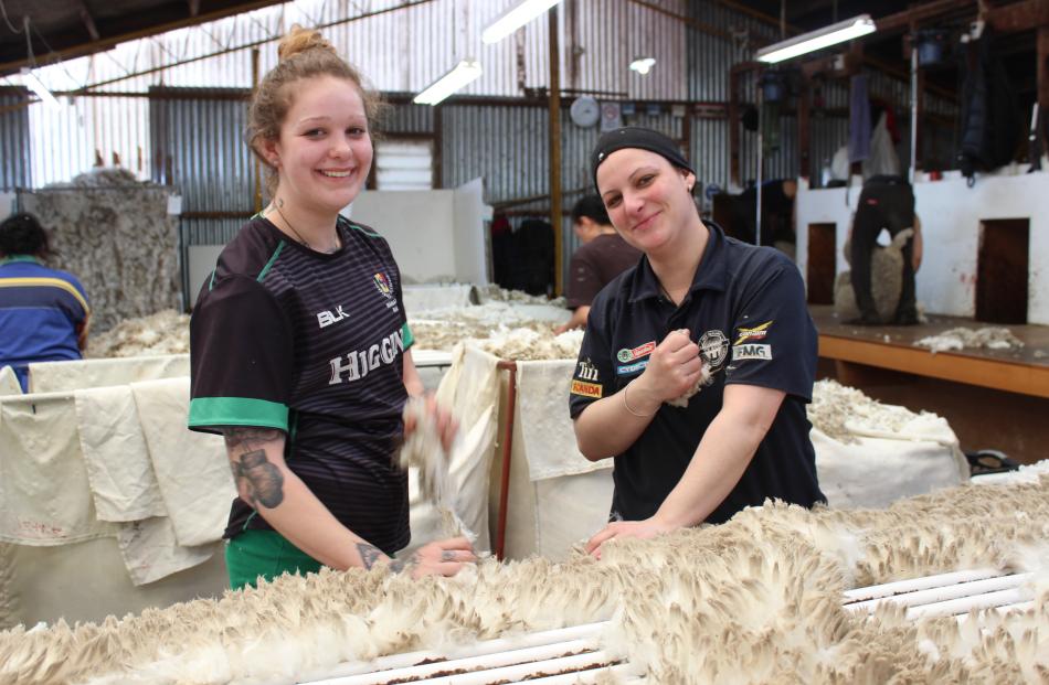 Once it's off the sheep, Molly Tapuke (left) and Amy Ferguson make sure there is nothing caught...