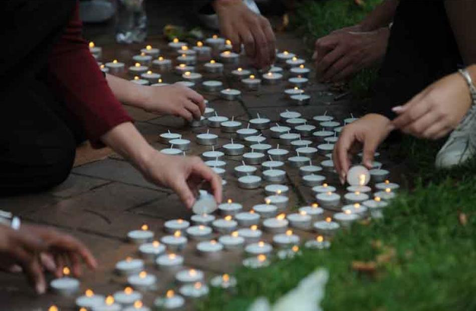 Candles layed during the 2 minutes silence in the Octagon for the victims of the Christchurch...