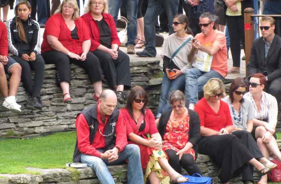 Reflecting . . . Some of those gathered at the Village Green in Queenstown yesterday afternoon...