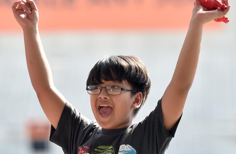Luiz Lazaro (8), of North East Valley School, triumphantly holds aloft a rubber frog he  used to ...