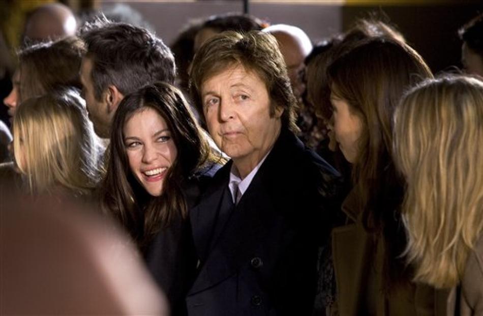 Paul McCartney and Liv Tyler, left, watch the show from designer Stella McCartney as part of her...