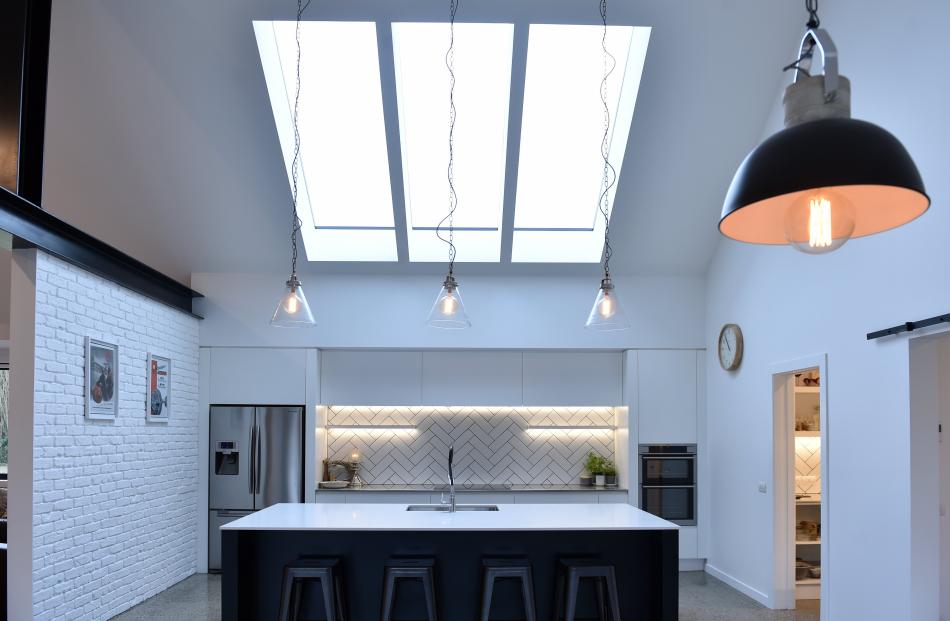 The window above the kitchen looks like three separate skylights but is one large piece of glass...