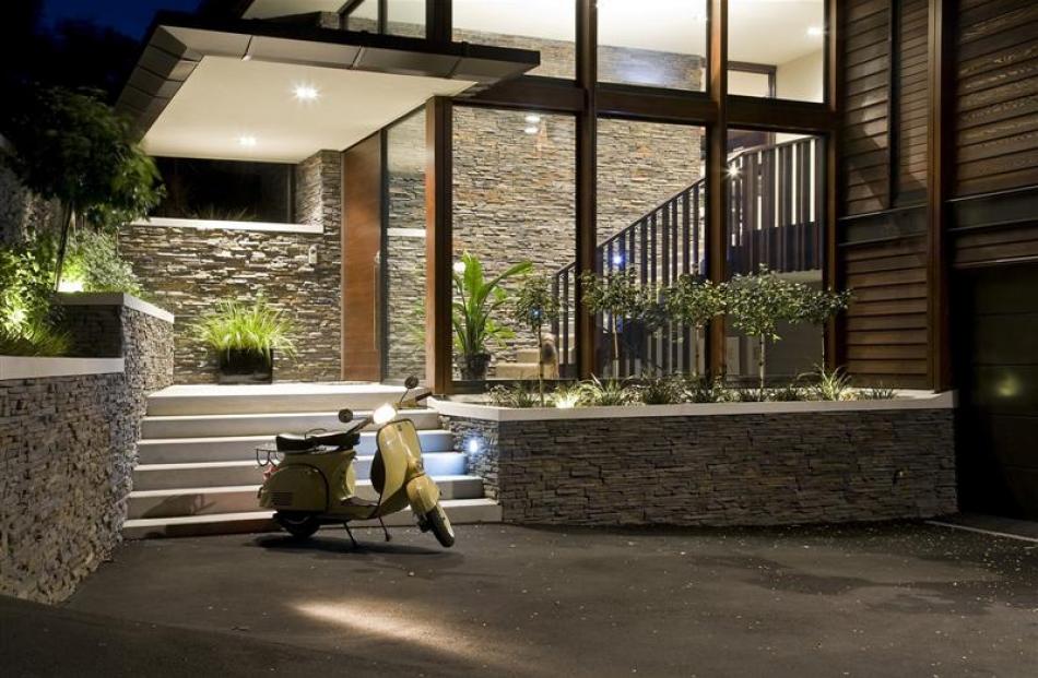 Stone is used on the base of the building and on low garden walls at the entrance