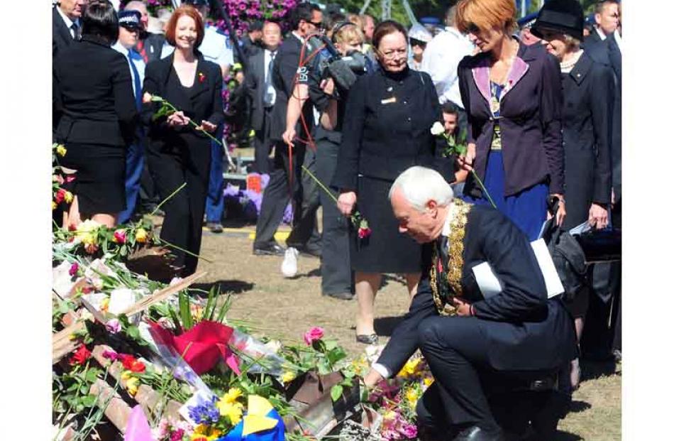 Christchurch mayor Bob Parker places a flower at the national memorial service held in the city's...