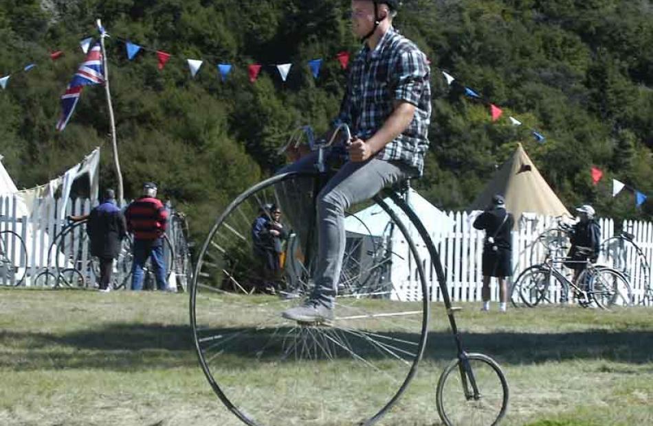 Bruce Thompson (16) of Wanaka rides past the bike camp on a penny farthing bike, his first time...
