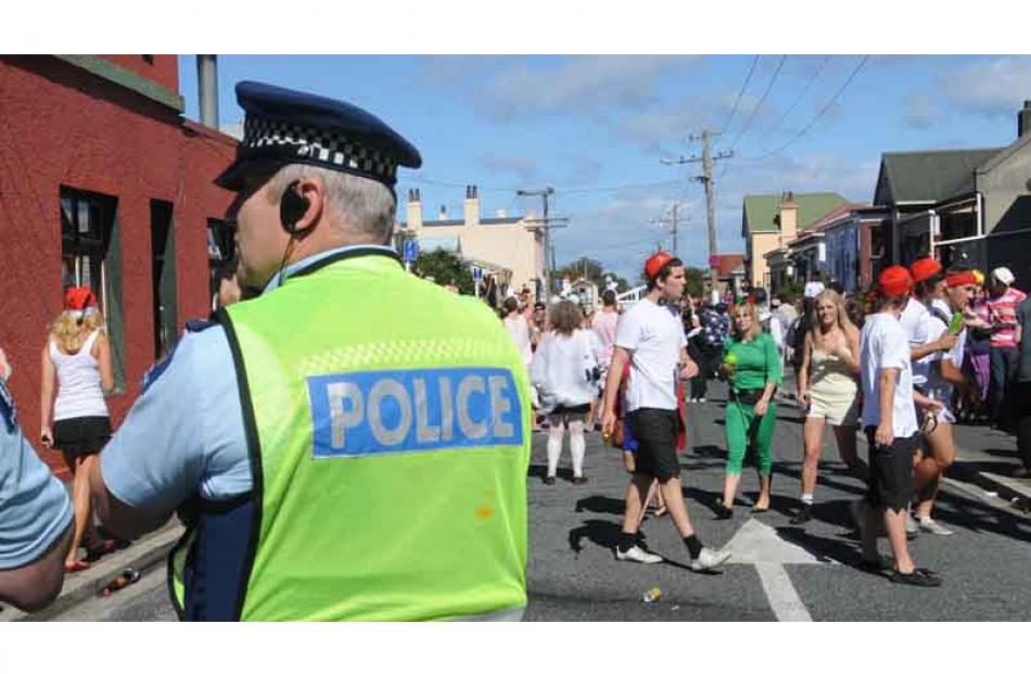 Police keep an eye on the entrance to the street. Photo by Peter McIntosh.