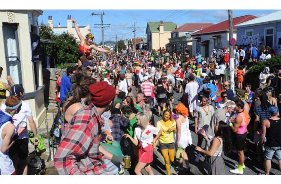 Partygoers fill the street. Photo by Peter McIntosh.