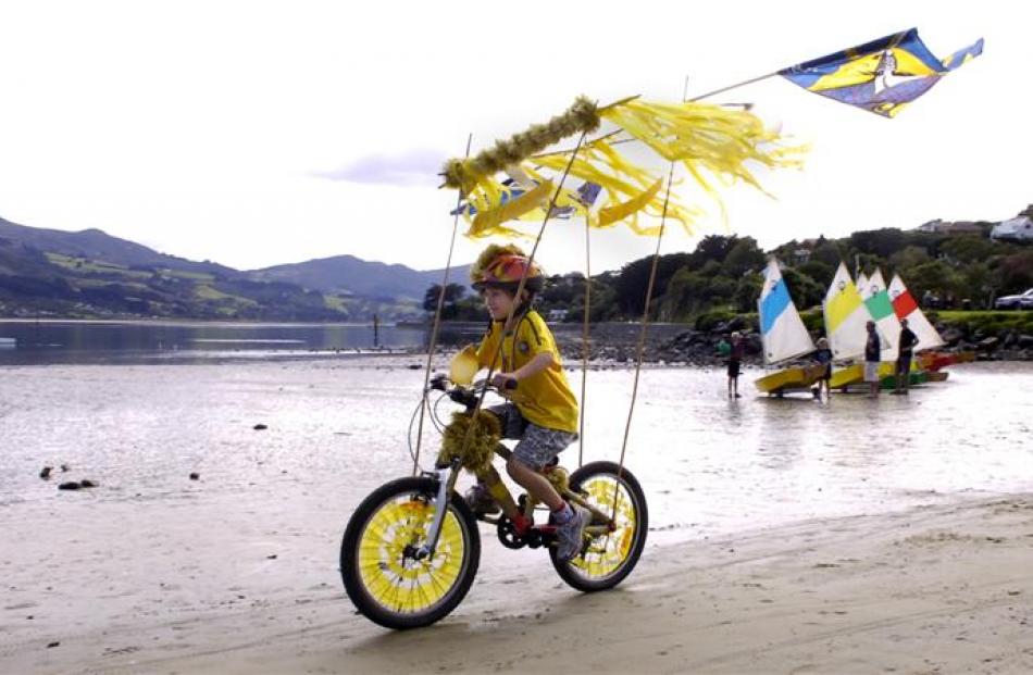 George Higham (7) rides his decorated bicycle along the beach at Macandrew Bay as part of a ...