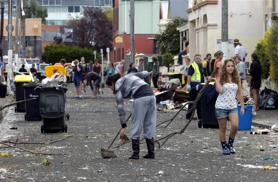 <b>10am:</b> Hyde St residents and helpers help clean up the mess yesterday.