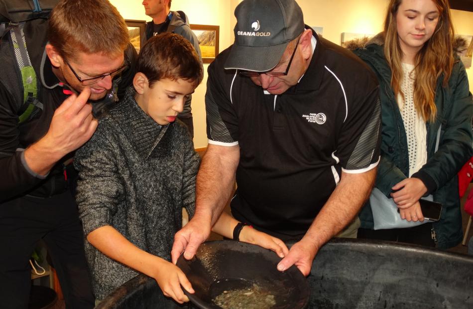 Stuart Ide (right), of Queenstown, teaches French visitor Pavel Kasberski (10) how to pan for...