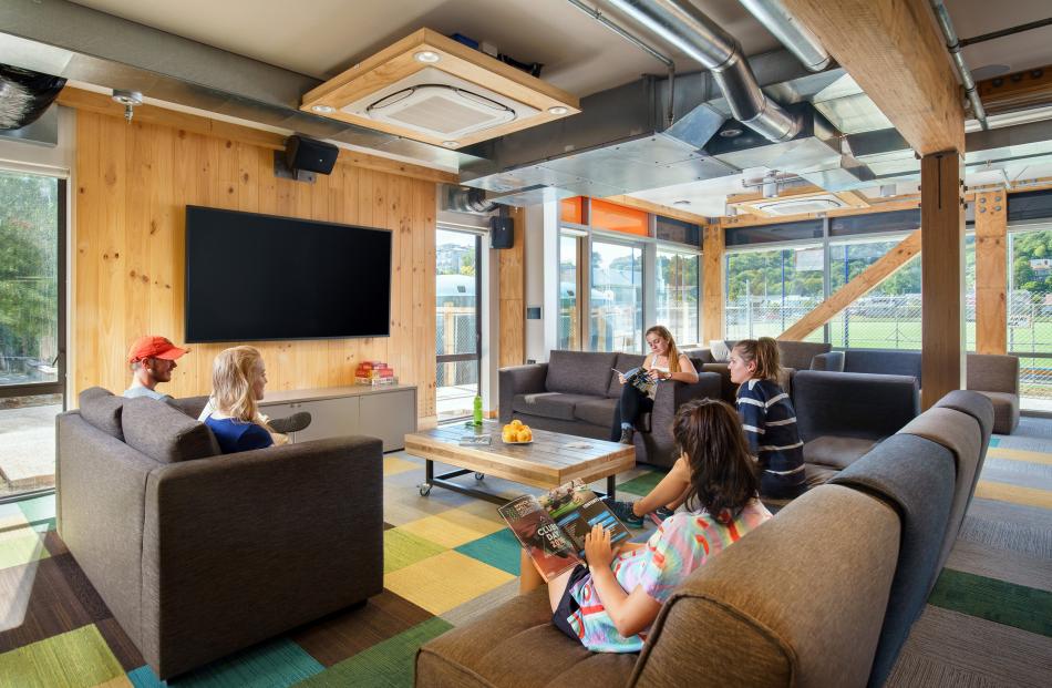 The main common room features comfy sofas and a television area. 