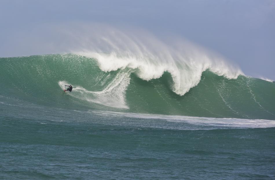Davy Woofindin rides a wave at a remote reefbreak in southern New Zealand. 