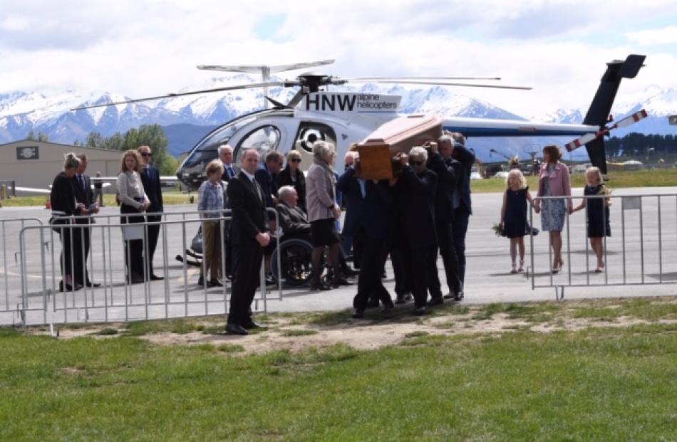 The family of Nick Wallis arrive at the funeral while his coffin is carried into the venue. Photo...