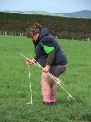 Bridget Henderson, of Waitane Young Farmers Club, works out the right length of an electric fence...
