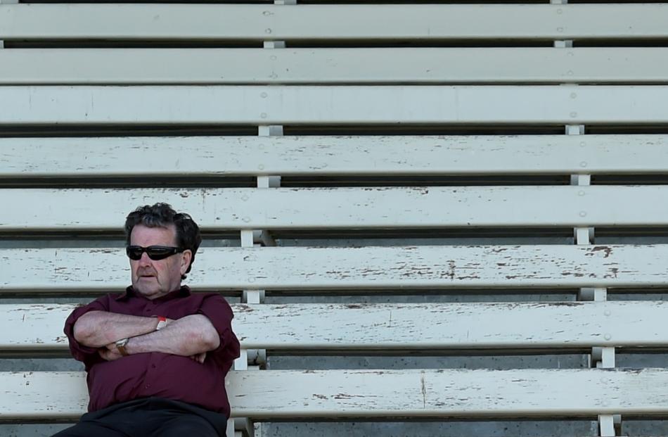 A man watches from the stand at the Wingatui Melbourne Cup day races yesterday. Photo: Peter...