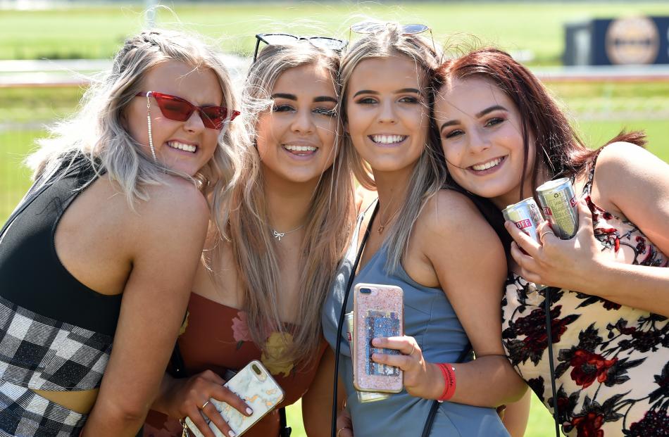 Race-goers (from left) Jordyn Patterson (18) Holly Ellis (19) Tayla Martin (18) and Caitlin Thomson (18), all of Dunedin, pose in the sun. Photo: Peter McIntosh