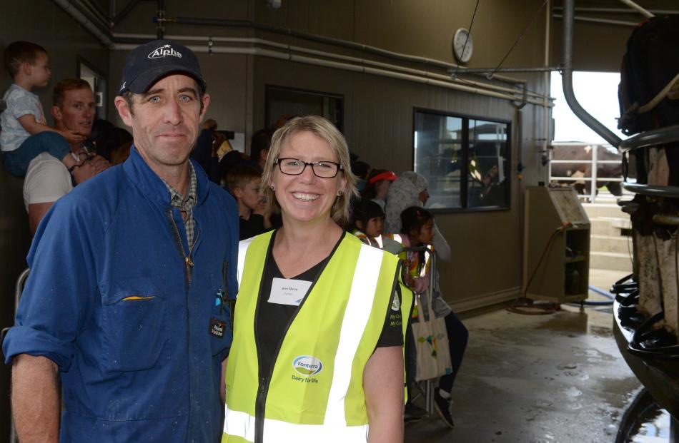 Farmers Duncan and Anne-Marie Wells help explain about milking sheds during an open day at their...