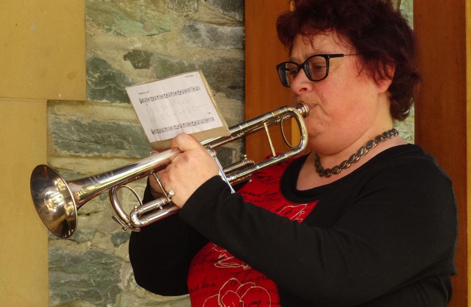 Emma Wilson plays  Last Post at the doors of St Peter’s Church, Queenstown, during an Armistice...