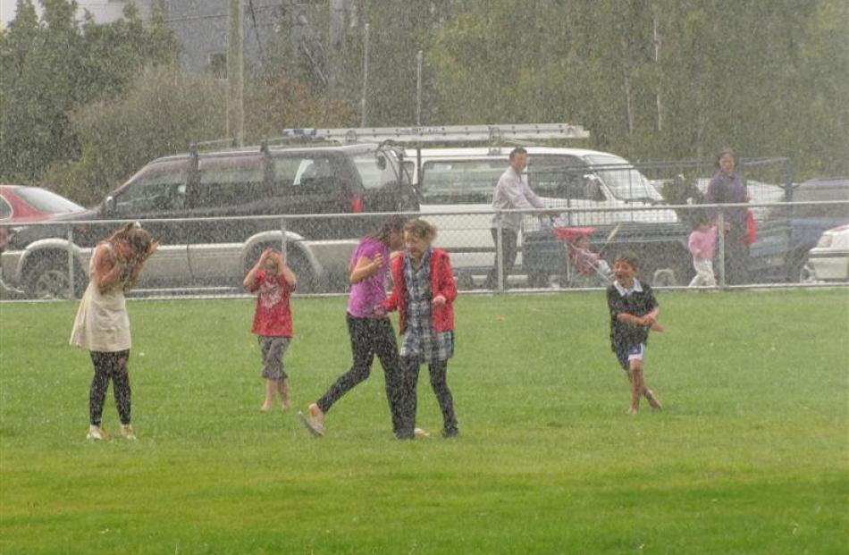 Children get drenched by the Queenstown Volunteer Fire Brigade water cannon.