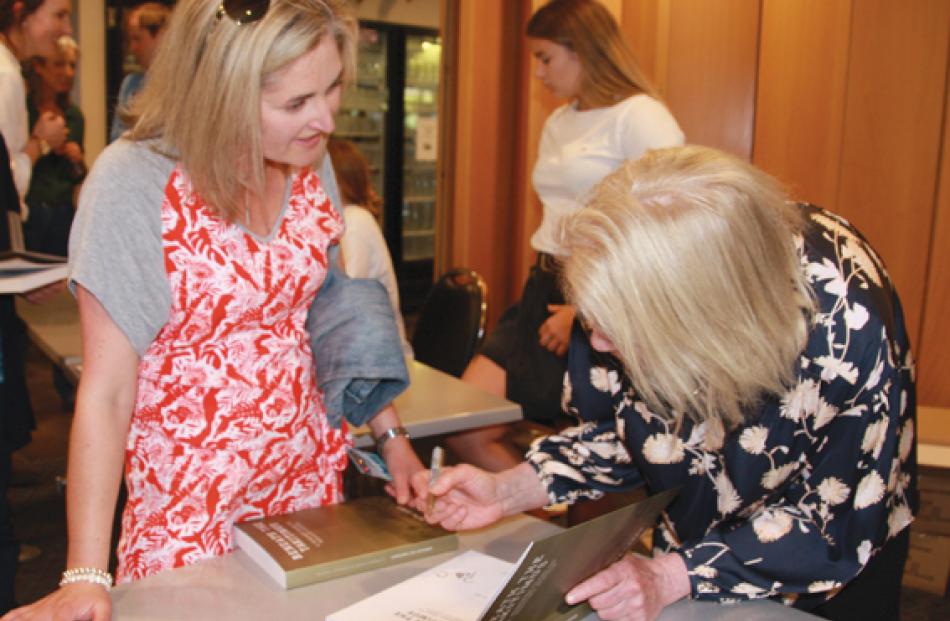 Bridget Speight, researcher for the book “Beneath the Takitimus”, signing the book  for Moretta...