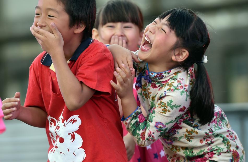 Performers leaving the stage (from left) Zhiqing Li (6), Natasha Birchall (6) and Siyao Zhu (6) erupt in fits of giggles during Chinese New Year celebrations at the Dunedin Chinese Garden in February. Photo: Peter McIntosh