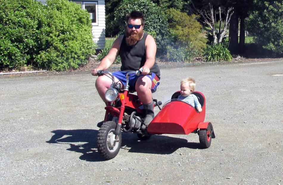 Hayden Sharp, of Alexandra, takes his son Ollie Sharp (18 months) for a ride in Owaka before Christmas. Photo: Wilma Sharp