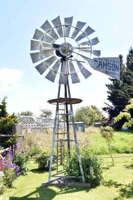 A restored windmill sits prominently in the front lawn.