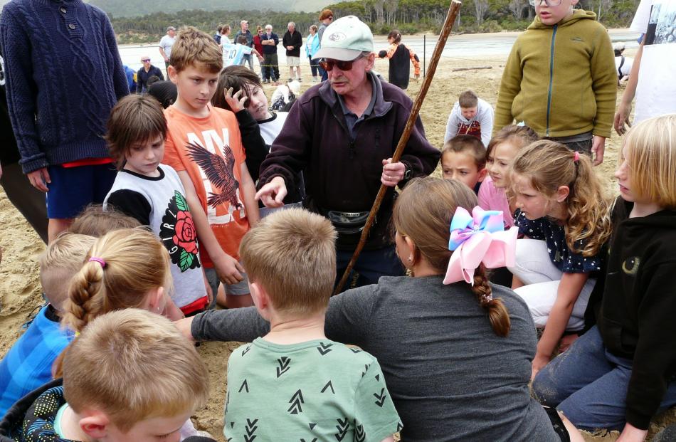 Papatowai Big Dig organiser Wayne Allen uses his "magic stick" to guide youngsters to a prize on New Year's Eve. Photo: Richard Davison